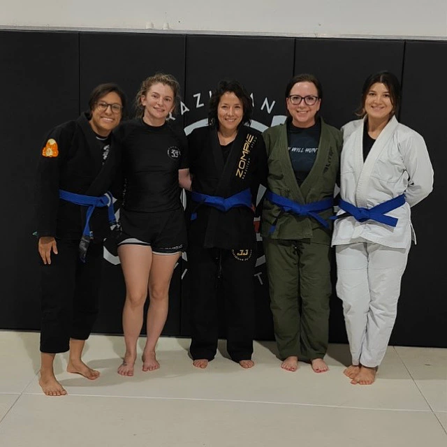 Women's BJJ class at Zombie BJJ — five women with blue belts