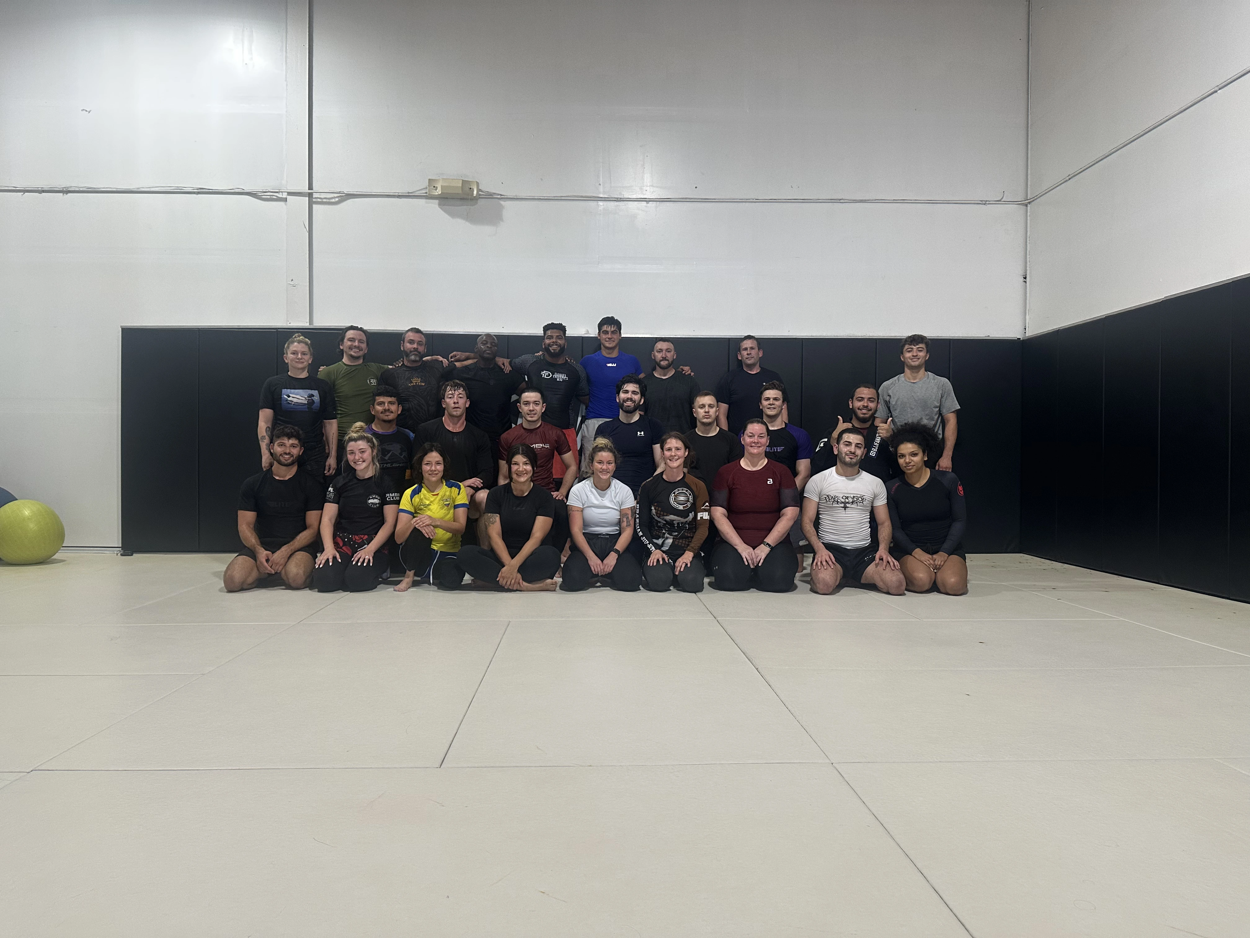 Large group photo of Zombie BJJ community members on the training mats
